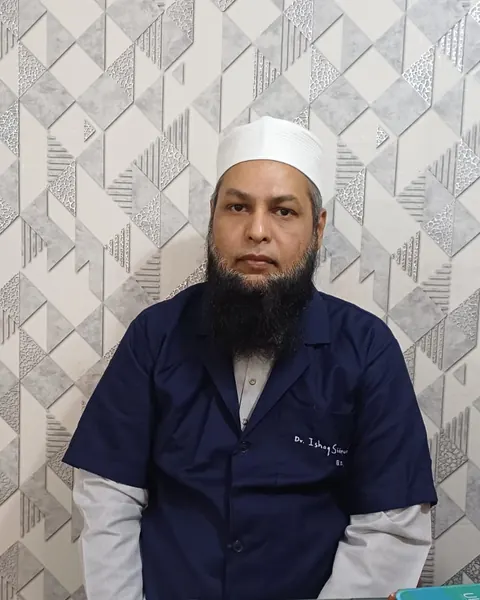 Dr. Ishaq Siddiqui, BDS, at his clinic in Shahbazar